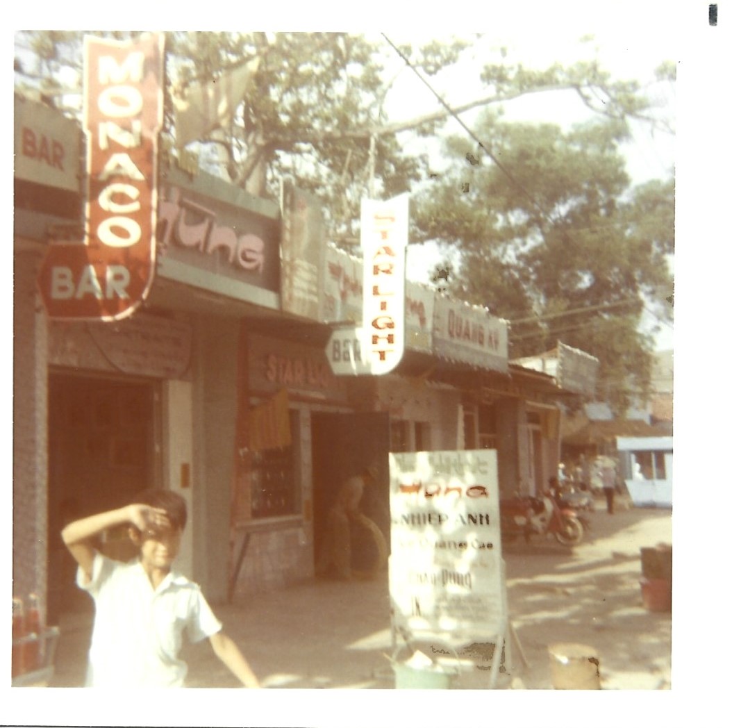 The Monaco and Star Light bars in Vung Tau. Aside from many establishments offering alcohol, this photograph also shows a photo studio (Nhiep Anh), where a GI could have portrait taken or get their film developed.

